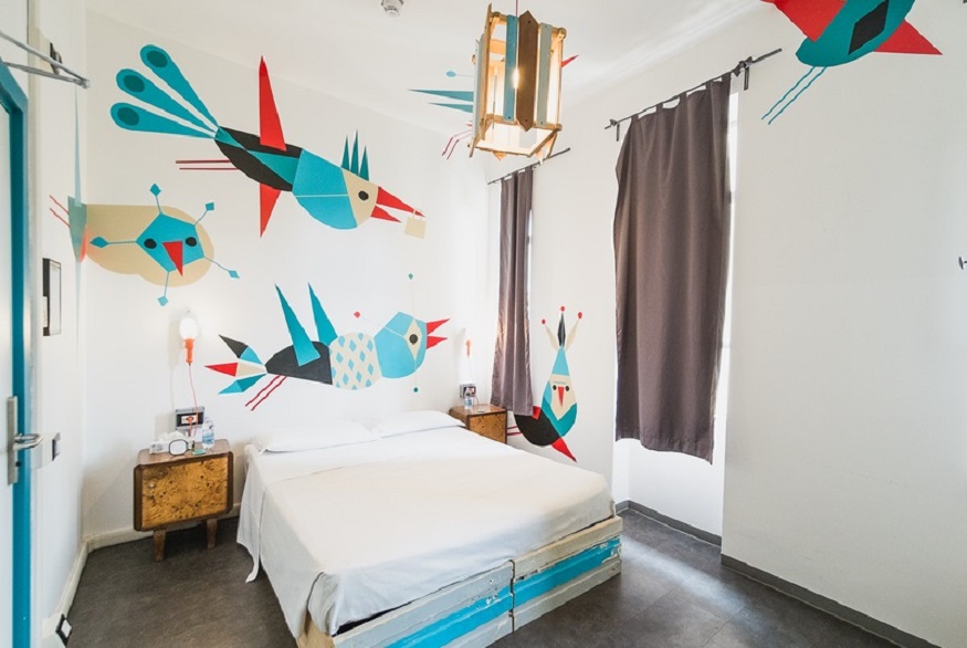 best hostels in milan, Madama Hostel and Bistrot private room with birds on the walls