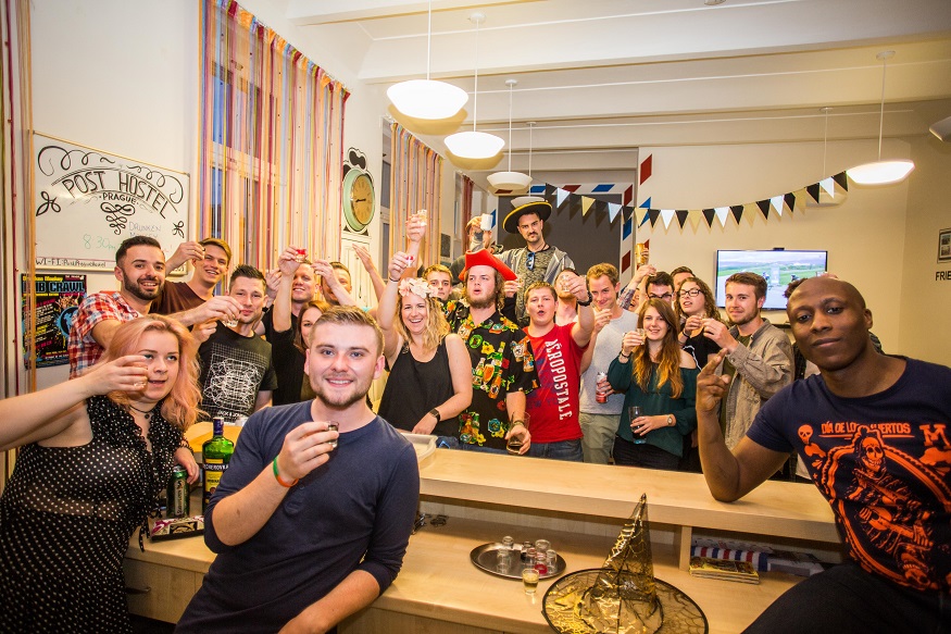 best party hostels in prague, people doing shots at Post Hostel Prague