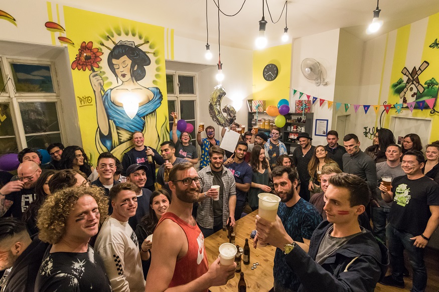 best party hostels in prague, big group of backpackers drinking at The Madhouse Prague
