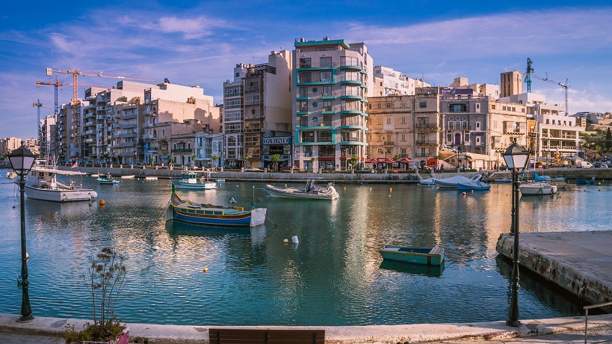 where to stay in malta - st julian's view of harbour with boats and promenade 