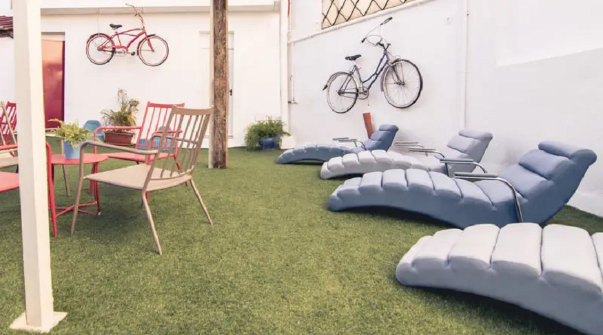 best hostels in seville, outdoor terrace with lounge chairs at Sevilla Inn Backpackers