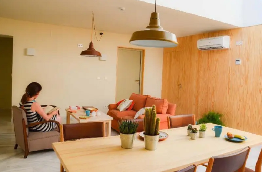 best hostels in seville, table and sofas at Nomad hostel